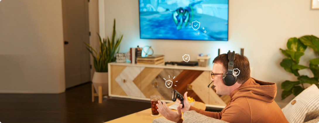 man playing video game with game consoles and headphones