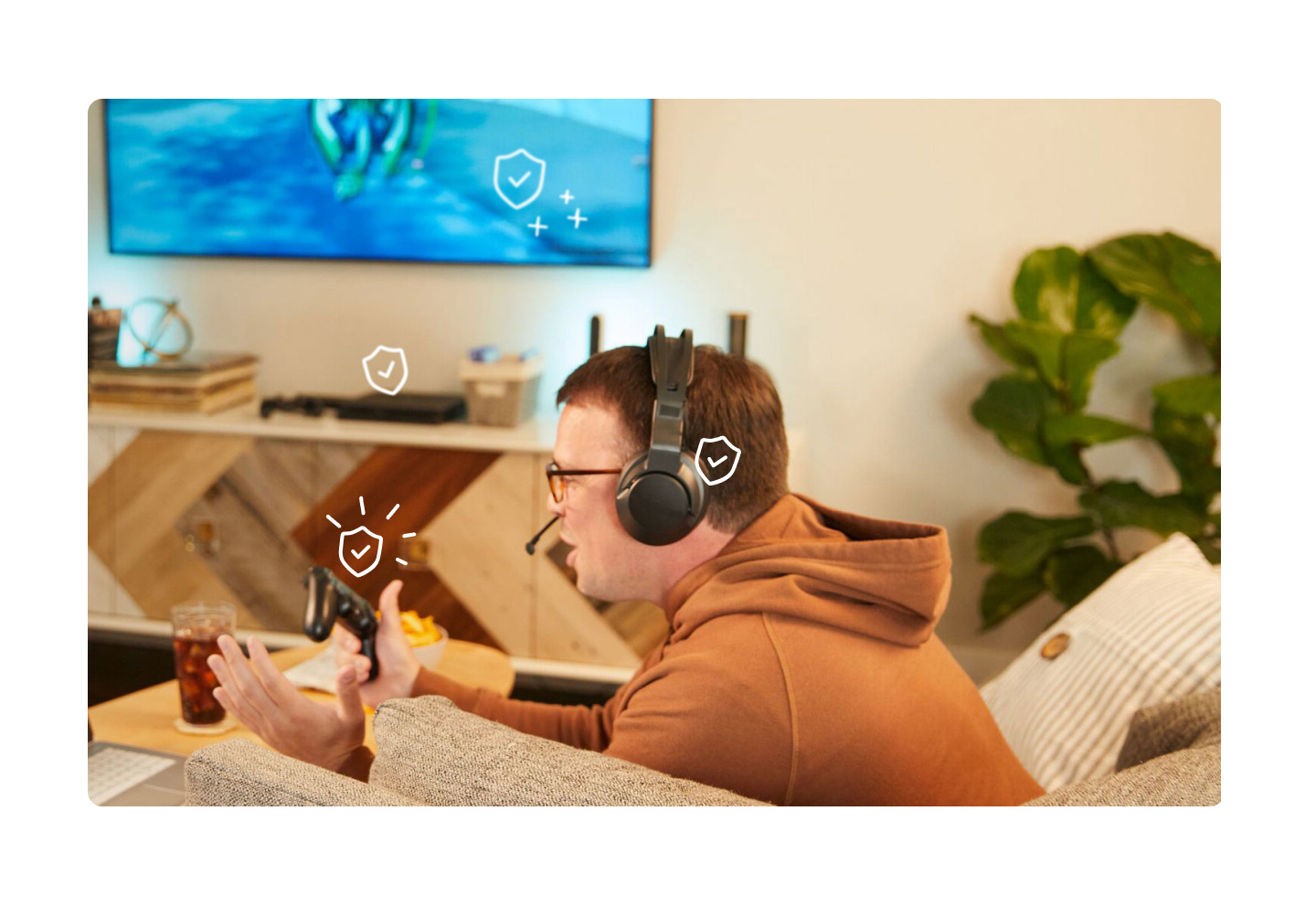 man playing video game with game consoles and headphones