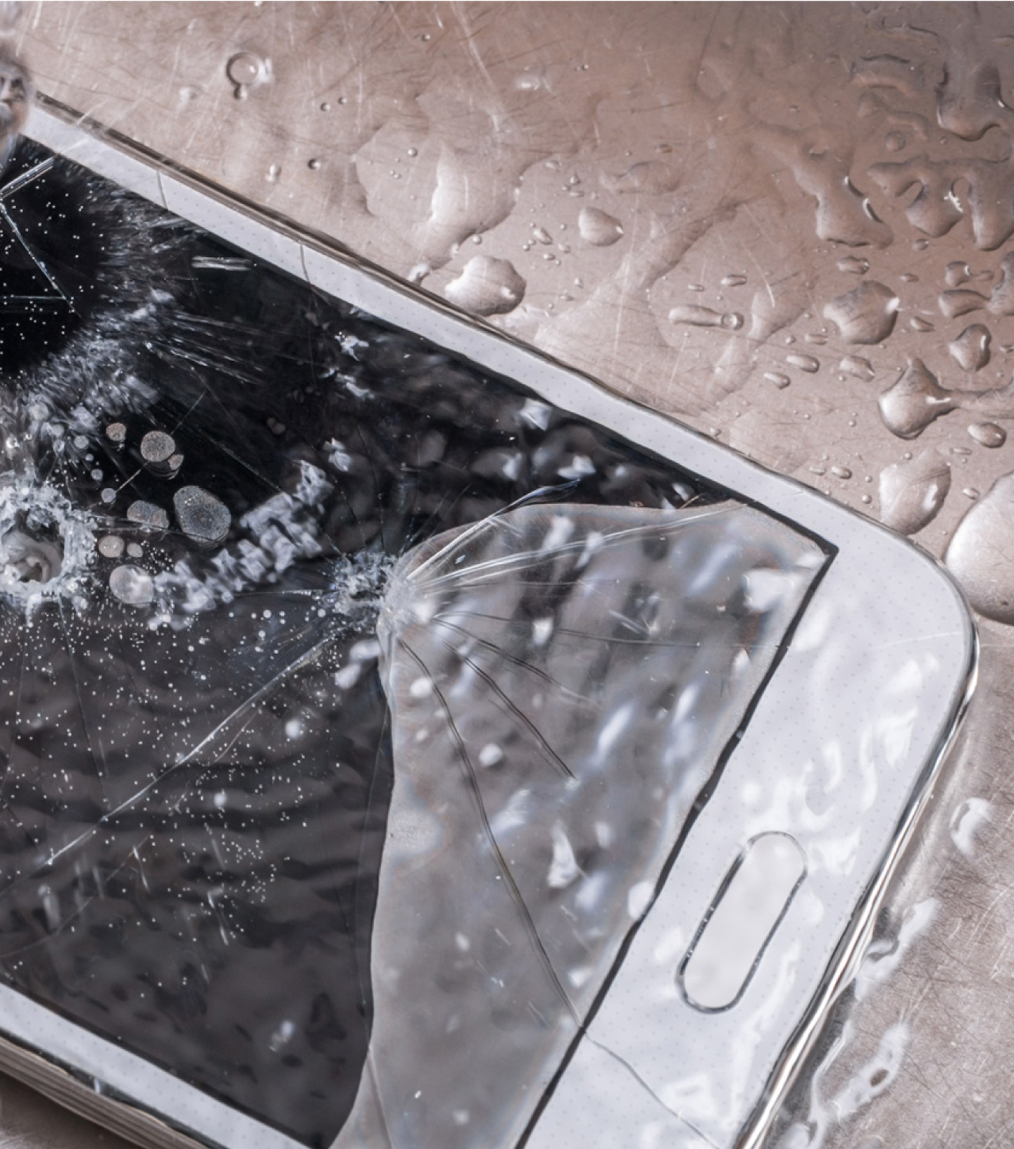 Smartphone with holes and cracked screen destroyed by water droplets