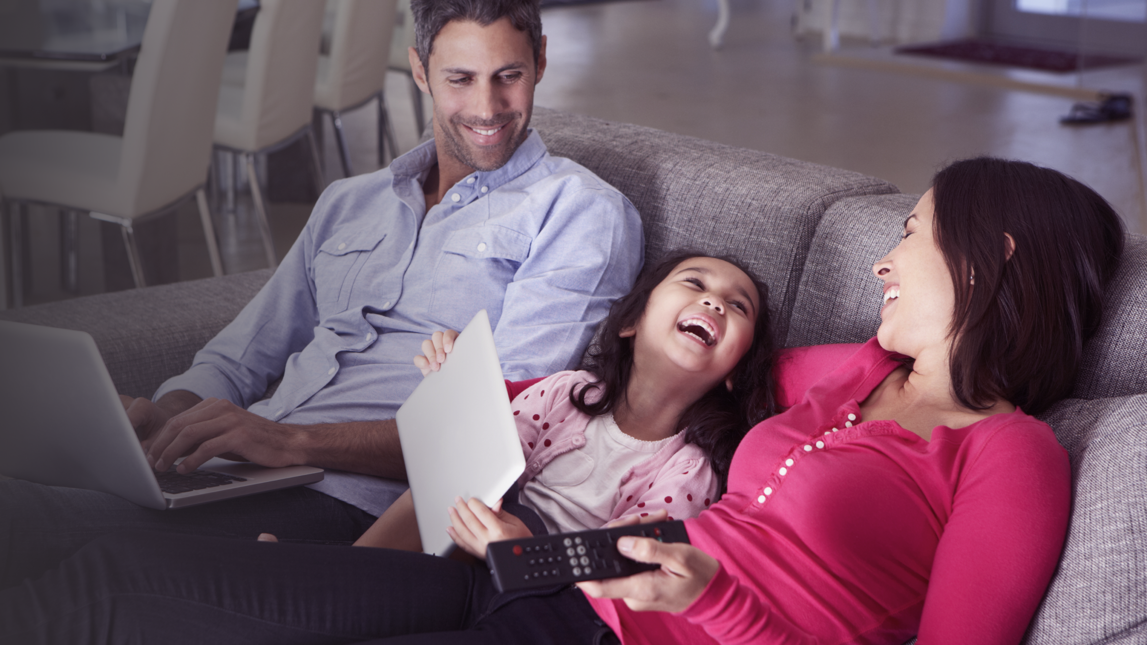 Family using technology in living room