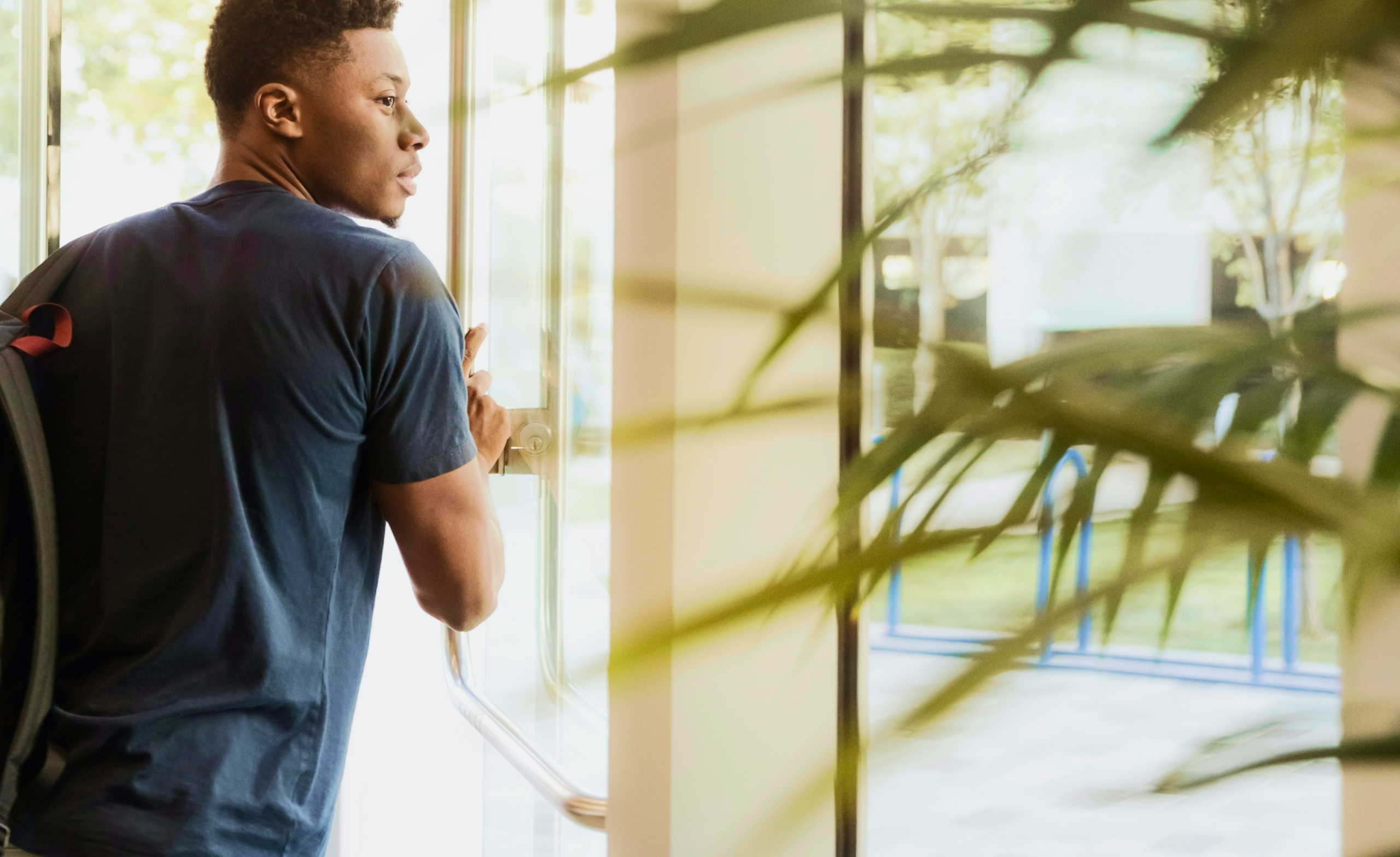 Man opening door to office building