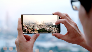 Young people take pictures of the buildings in the city