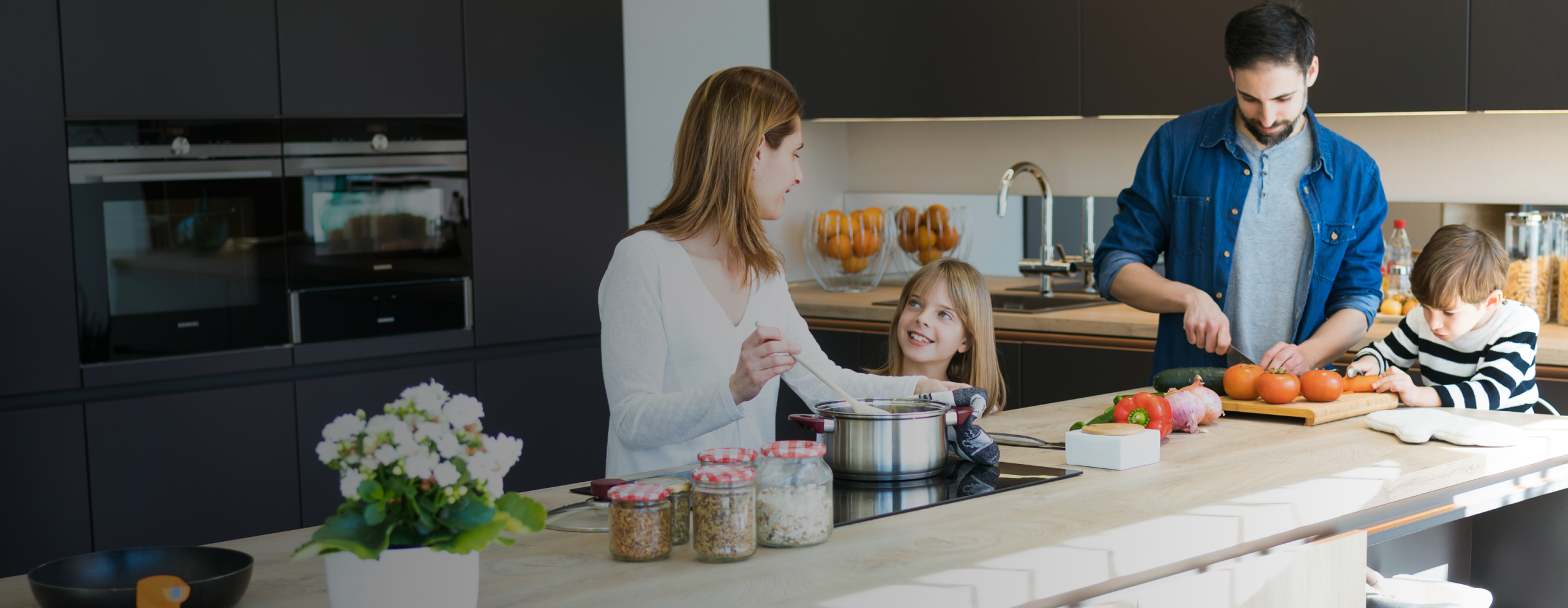 family in kitchen cooking dinner